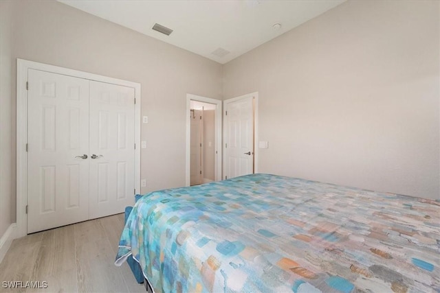 bedroom with light hardwood / wood-style flooring and a closet