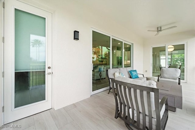 exterior space featuring a wooden deck, ceiling fan, and an outdoor hangout area