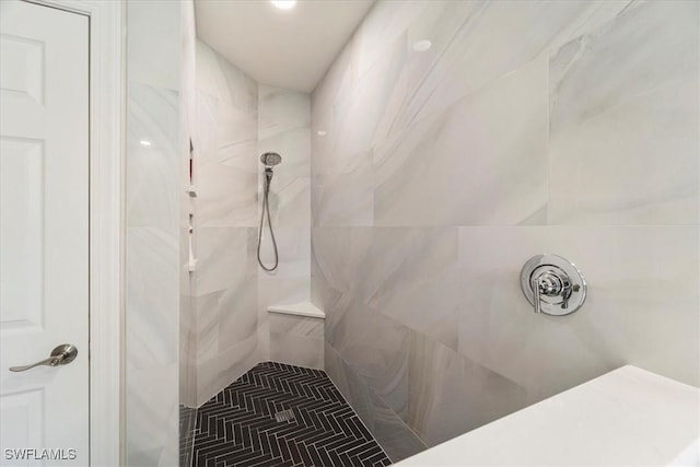 bathroom with a tile shower