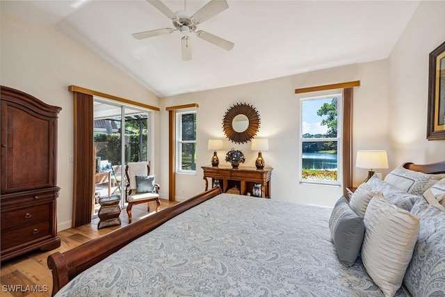 bedroom with multiple windows, ceiling fan, light hardwood / wood-style floors, and lofted ceiling