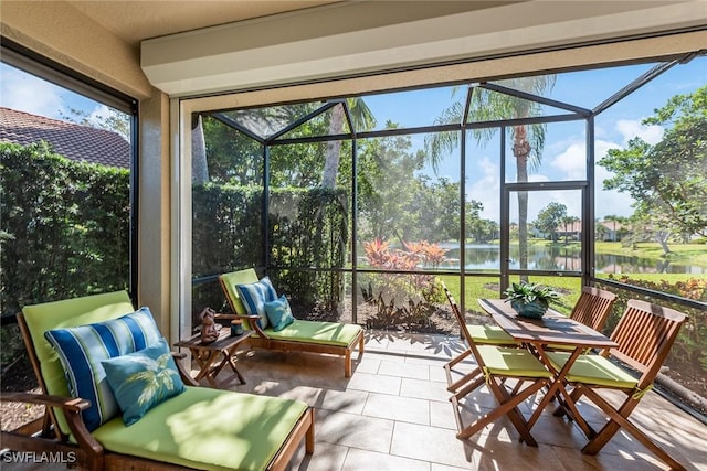 sunroom / solarium with a water view