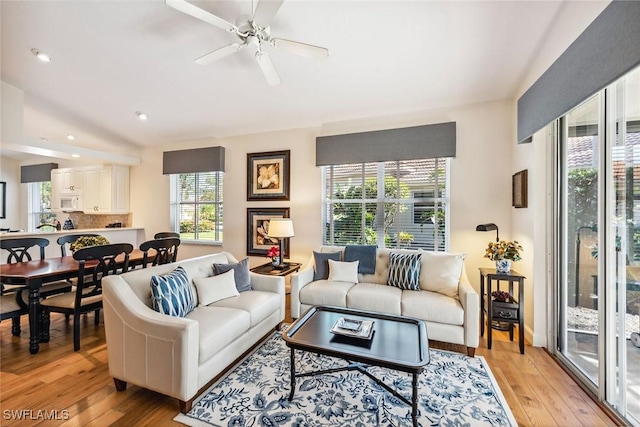 living room featuring plenty of natural light, light hardwood / wood-style floors, and ceiling fan