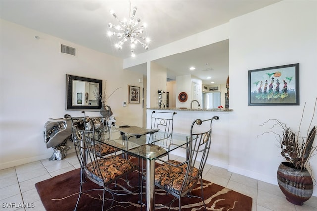 dining room featuring an inviting chandelier and light tile patterned flooring