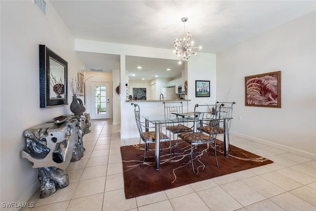 dining area with an inviting chandelier and light tile patterned flooring