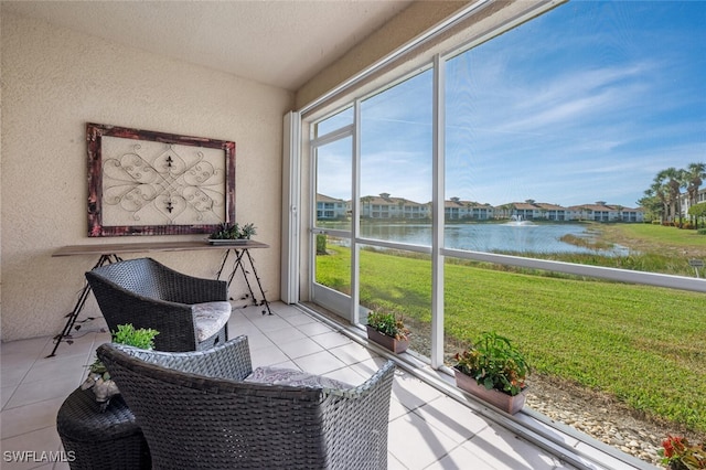 sunroom / solarium featuring a water view