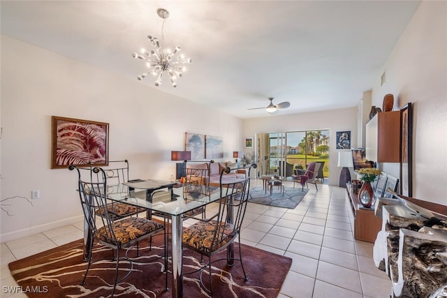 tiled dining area featuring ceiling fan with notable chandelier