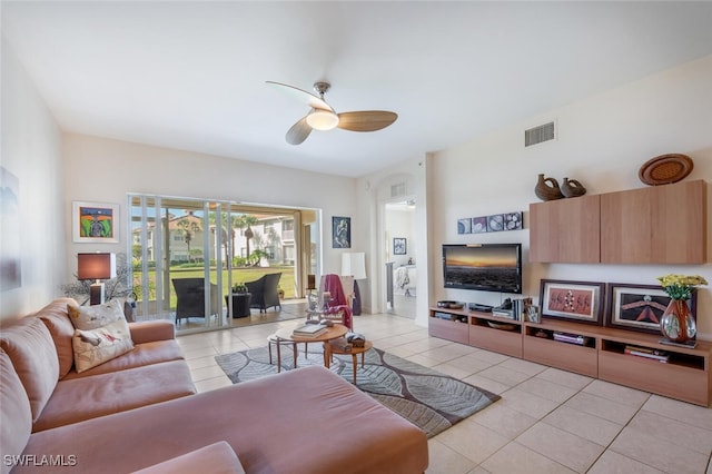 tiled living room with ceiling fan