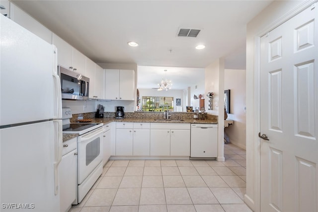 kitchen featuring white cabinetry, sink, decorative light fixtures, white appliances, and light tile patterned flooring