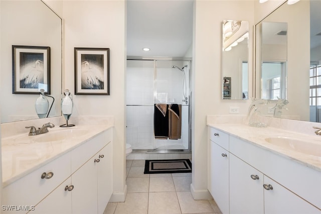 bathroom with toilet, vanity, tile patterned floors, and walk in shower