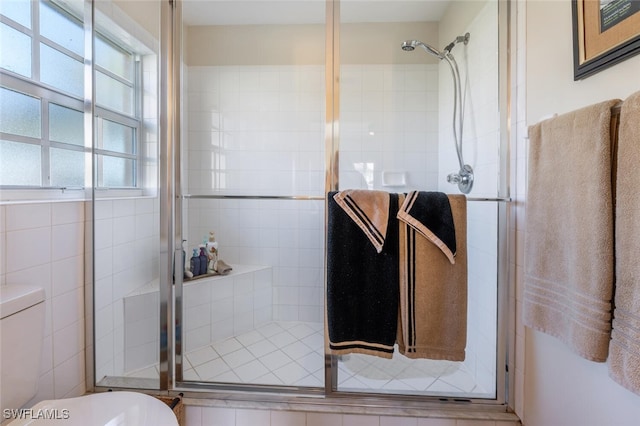 bathroom with toilet and a shower with shower door