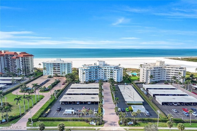 birds eye view of property with a water view and a view of the beach