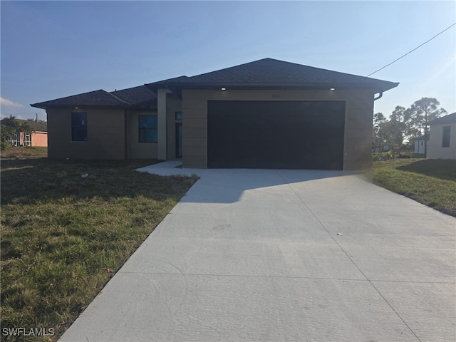 view of front of property with a front yard and a garage