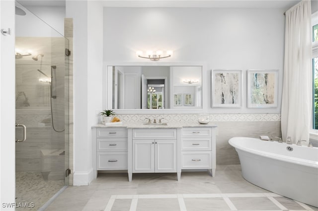 bathroom with shower with separate bathtub and vanity