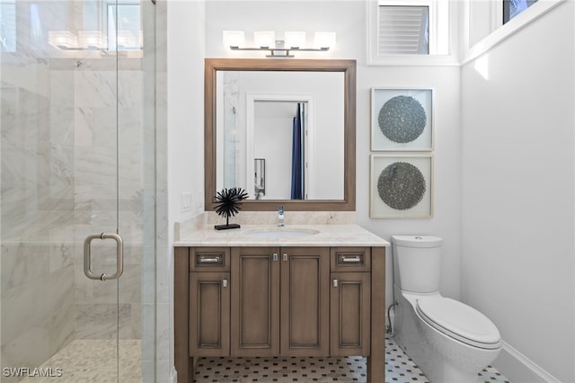 bathroom with toilet, an enclosed shower, and vanity