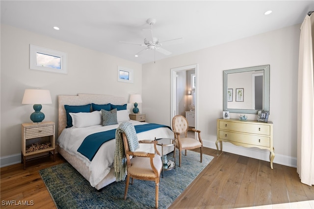 bedroom with ceiling fan and hardwood / wood-style floors