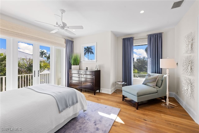 bedroom with access to exterior, ceiling fan, and light hardwood / wood-style flooring