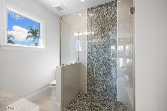 bathroom with toilet, walk in shower, and tile patterned floors