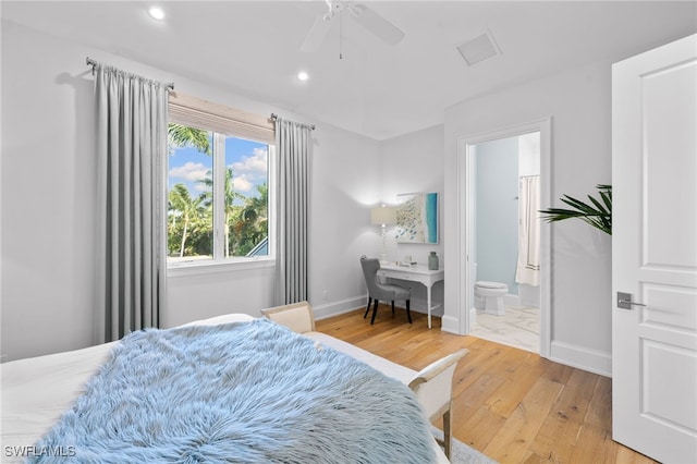 bedroom with ensuite bathroom, wood-type flooring, and ceiling fan