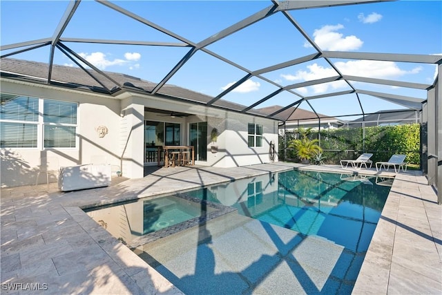 view of pool featuring a lanai, a patio area, and an outdoor bar