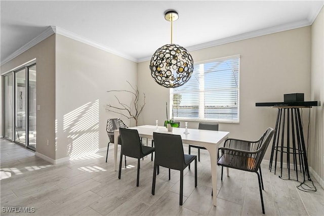 dining room with light wood-type flooring and ornamental molding