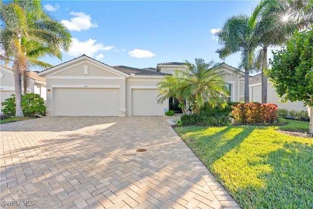 view of front of house featuring a garage and a front yard