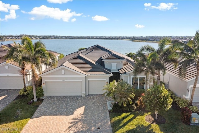 view of front of home with a water view and a garage