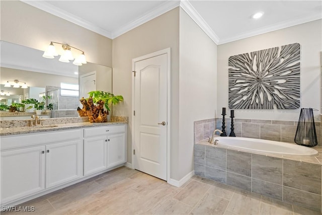 bathroom featuring vanity, ornamental molding, and tiled tub