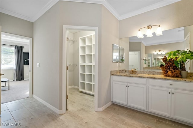 bathroom featuring crown molding and vanity