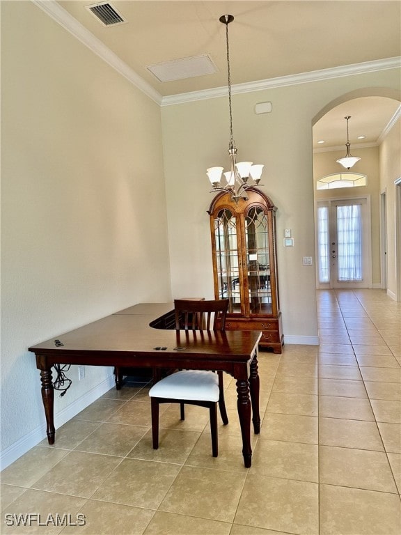 dining area with an inviting chandelier, ornamental molding, and tile patterned floors