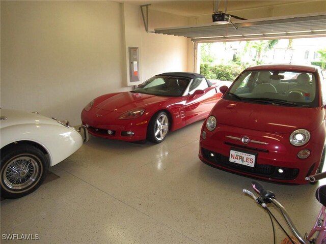 garage with electric panel and a garage door opener