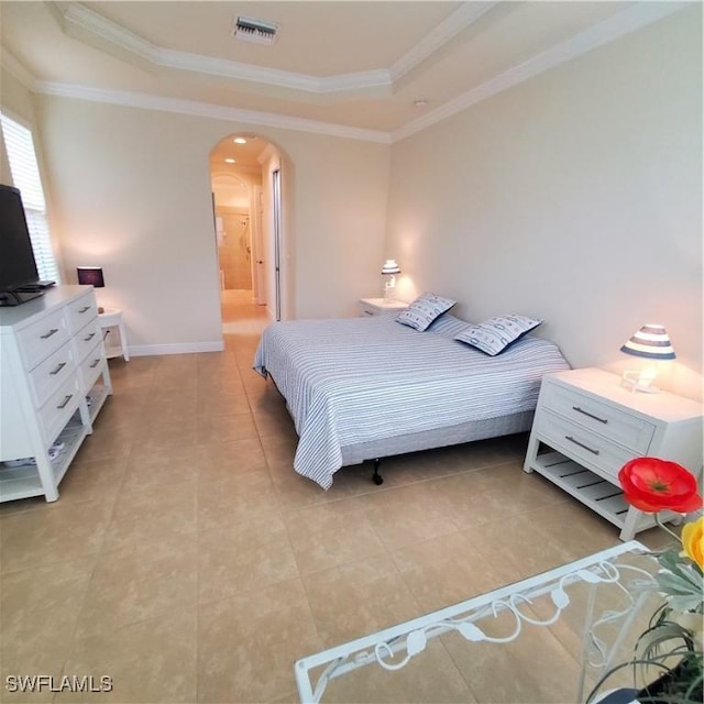 tiled bedroom featuring crown molding and a tray ceiling