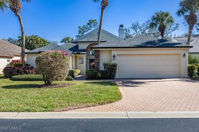 single story home featuring a front yard and a garage