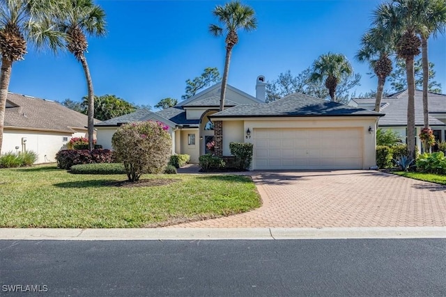 view of front of home featuring a front yard and a garage