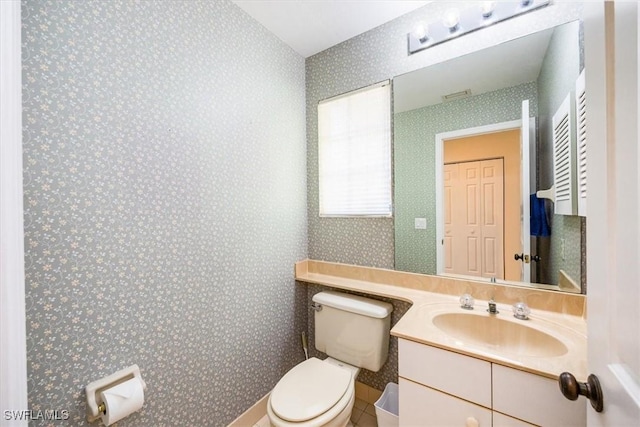 bathroom with tile patterned floors, vanity, and toilet