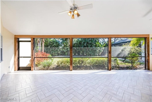 unfurnished sunroom with ceiling fan