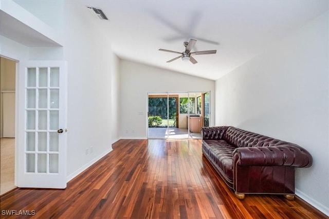 living room with dark hardwood / wood-style flooring, ceiling fan, and lofted ceiling