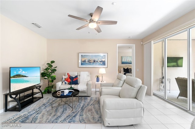 living room featuring ceiling fan and light tile patterned floors