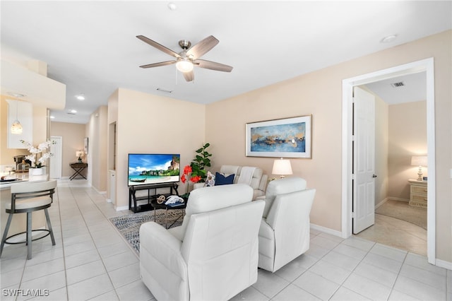 living room featuring ceiling fan and light tile patterned floors