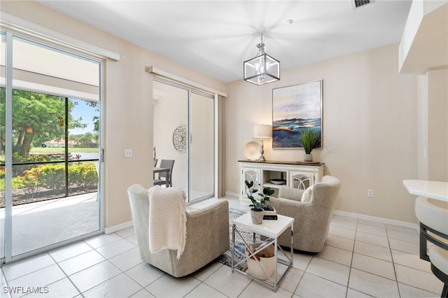 living room featuring a notable chandelier and light tile patterned floors