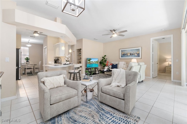 tiled living room with ceiling fan