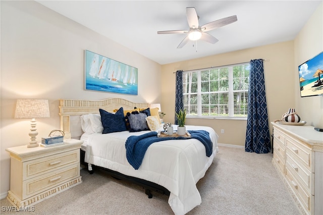 bedroom with ceiling fan and light carpet