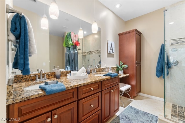 bathroom with tile patterned flooring, vanity, and walk in shower