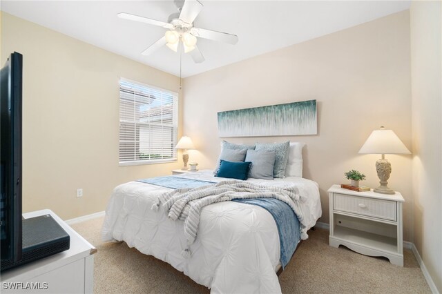 bedroom featuring ceiling fan and light carpet