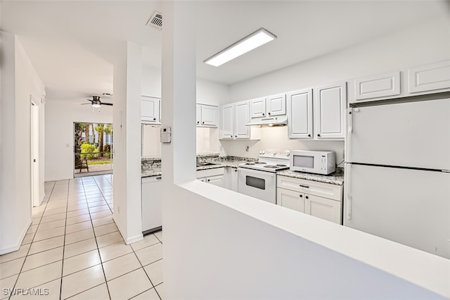 kitchen featuring ceiling fan, light tile patterned flooring, white cabinets, and white appliances