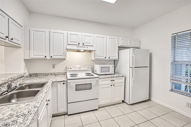 kitchen with white cabinets, light tile patterned floors, sink, and white appliances