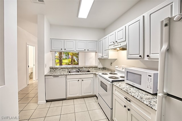 kitchen with sink, light tile patterned floors, white cabinets, and white appliances