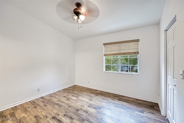 empty room with hardwood / wood-style floors and ceiling fan