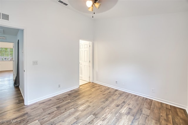 unfurnished room featuring ceiling fan, high vaulted ceiling, and light hardwood / wood-style flooring