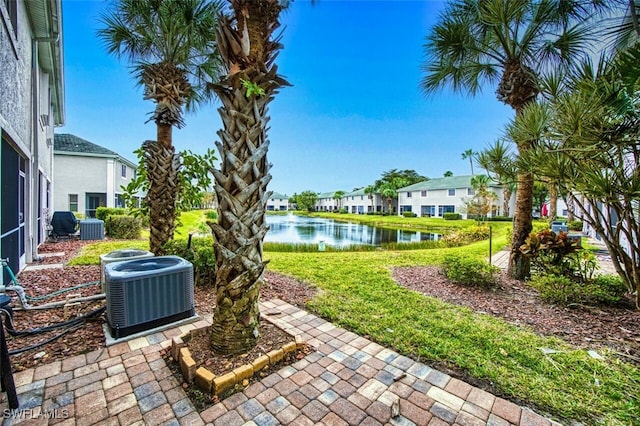 view of yard featuring a water view and central AC