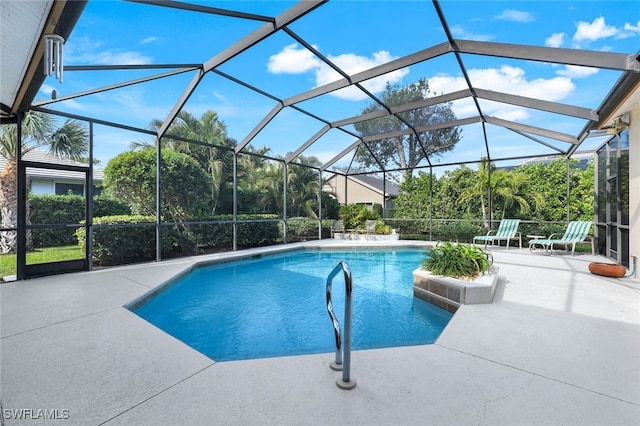 view of pool with a lanai and a patio